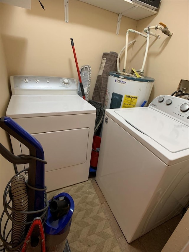 laundry area with electric water heater and washer and dryer