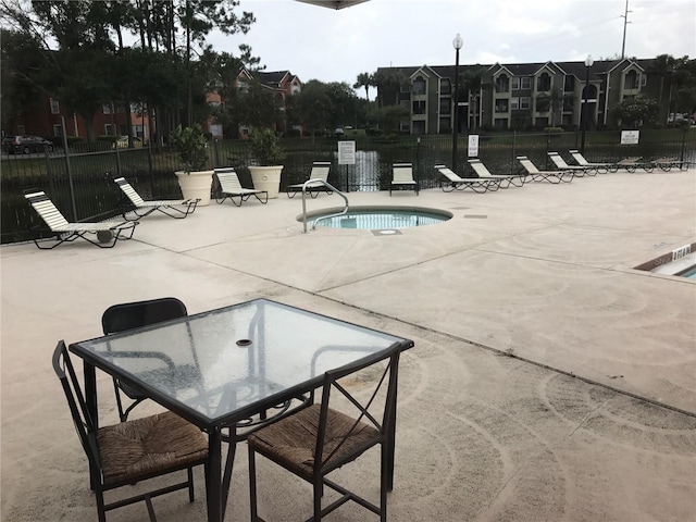 view of swimming pool with a patio area and a community hot tub