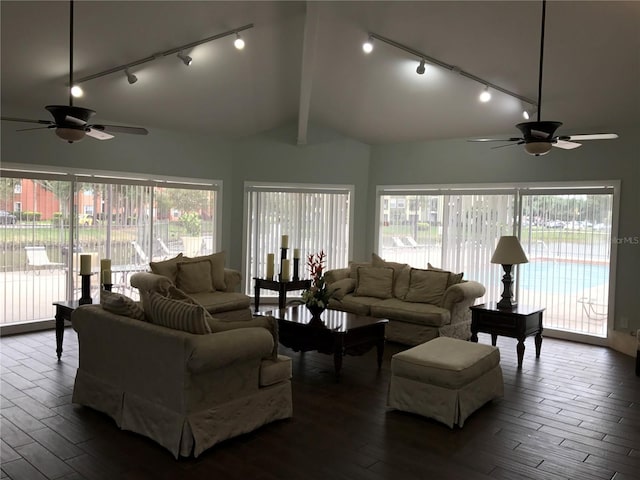 living room featuring ceiling fan and lofted ceiling with beams