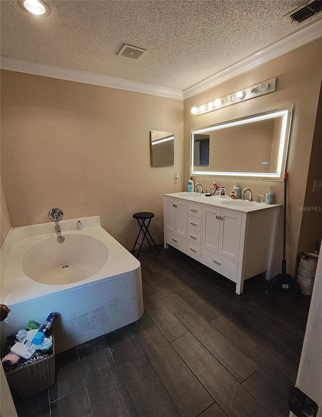 bathroom with vanity, wood-type flooring, crown molding, and a textured ceiling