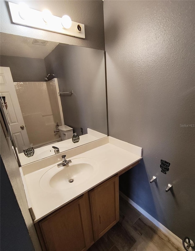 full bathroom with shower / bath combination, toilet, vanity, and hardwood / wood-style floors