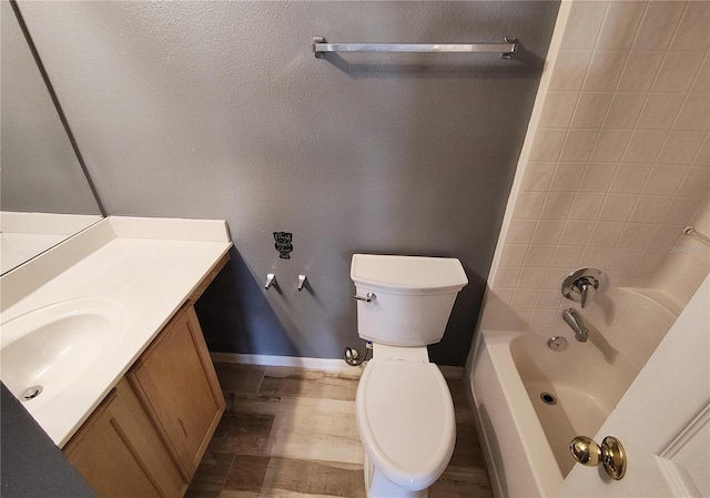 full bathroom with toilet, vanity, and tiled shower / bath