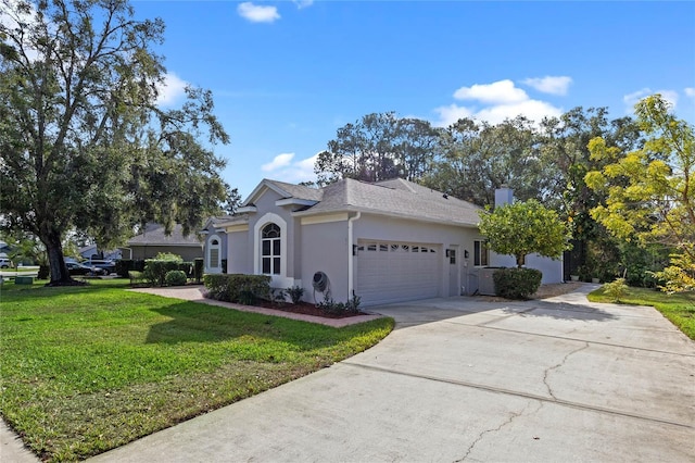 view of front of house with a garage and a front lawn