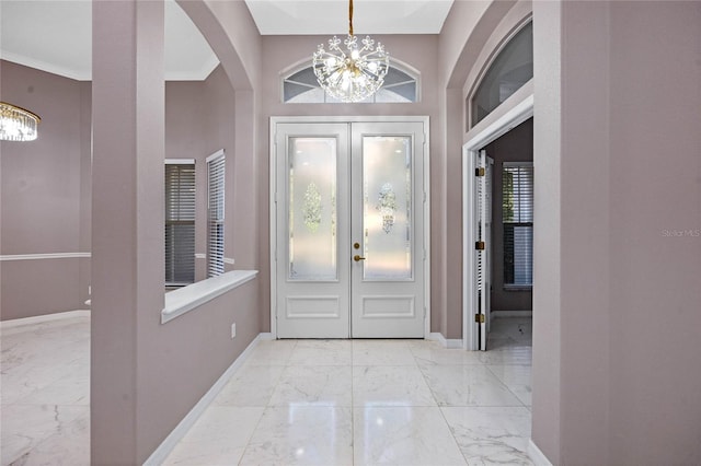 entrance foyer featuring an inviting chandelier and ornamental molding