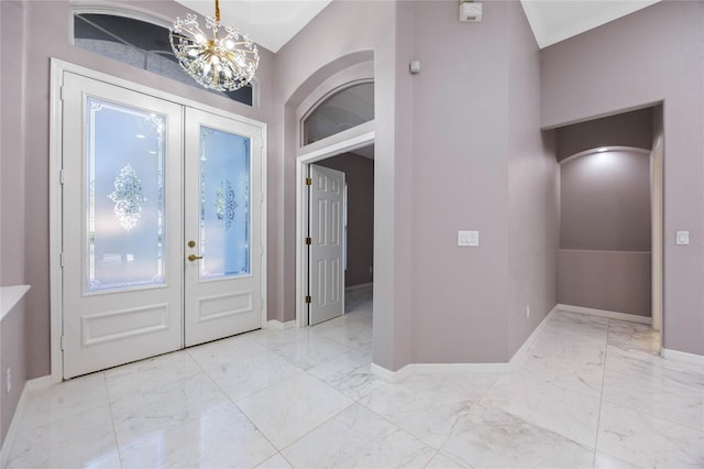 entryway featuring french doors and a notable chandelier