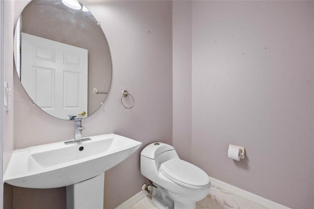 bathroom featuring toilet and sink