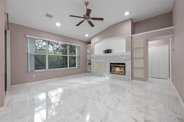 unfurnished living room with ceiling fan, lofted ceiling, and a fireplace