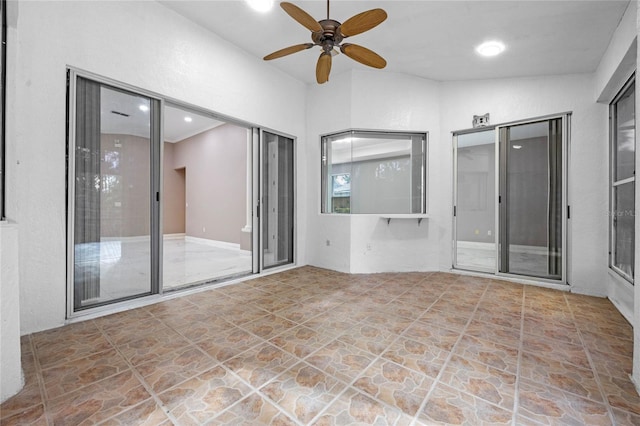 unfurnished room with ceiling fan and vaulted ceiling