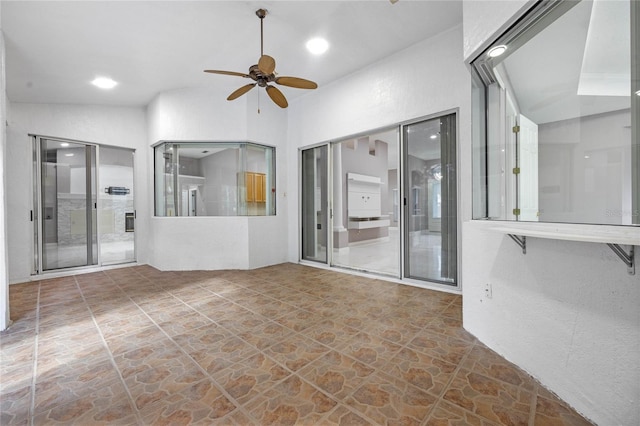 unfurnished room with ceiling fan and lofted ceiling