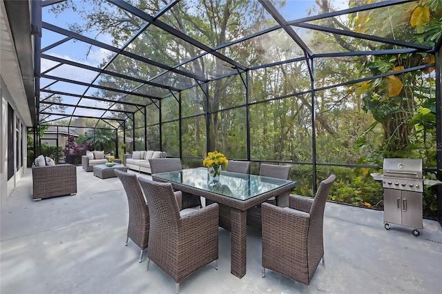 view of patio / terrace with a grill, an outdoor living space, and glass enclosure