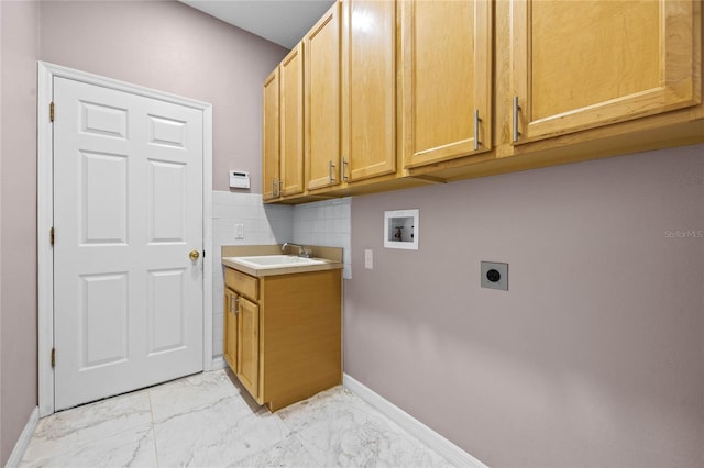 washroom featuring hookup for a washing machine, sink, cabinets, and hookup for an electric dryer