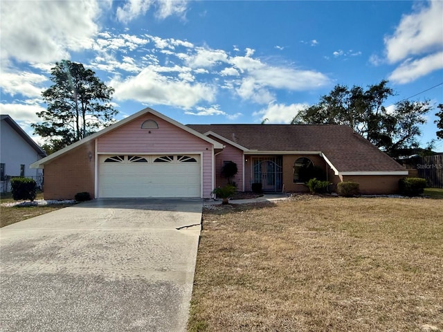 ranch-style house featuring a front lawn and a garage