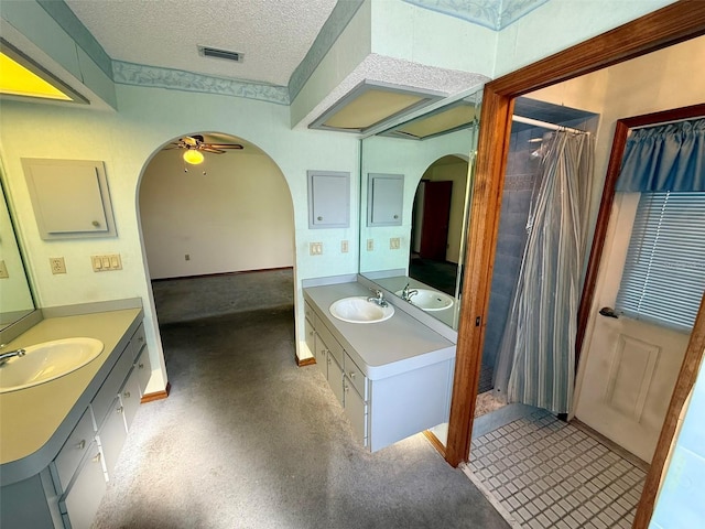 bathroom with vanity, a textured ceiling, and ceiling fan