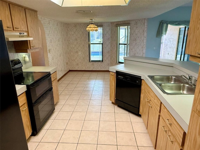 kitchen featuring a textured ceiling, sink, black appliances, pendant lighting, and light tile patterned floors