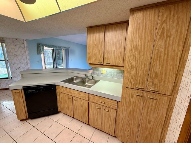 kitchen with sink, a textured ceiling, black dishwasher, a healthy amount of sunlight, and kitchen peninsula