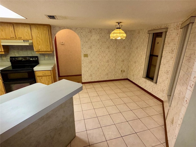 kitchen with light tile patterned flooring, hanging light fixtures, a textured ceiling, and black range with electric cooktop