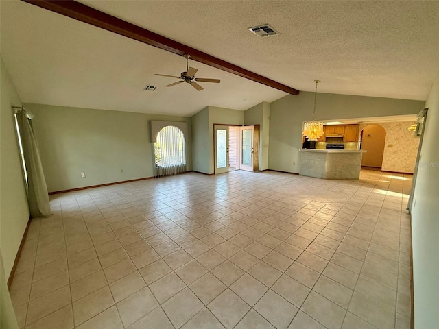 unfurnished living room with a textured ceiling, vaulted ceiling with beams, ceiling fan, and light tile patterned flooring