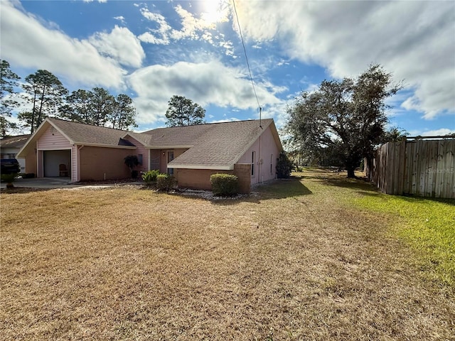 view of property exterior featuring a lawn and a garage