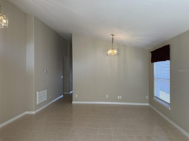 unfurnished room featuring light tile patterned floors and a notable chandelier