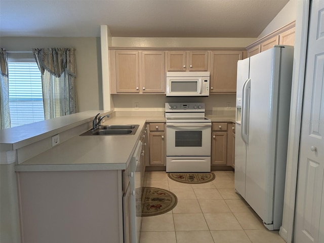 kitchen featuring kitchen peninsula, white appliances, sink, light brown cabinets, and light tile patterned flooring