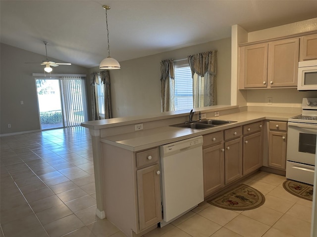 kitchen with kitchen peninsula, white appliances, vaulted ceiling, sink, and light tile patterned floors