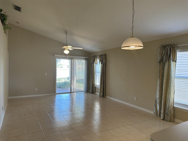 spare room featuring ceiling fan, light tile patterned floors, and vaulted ceiling