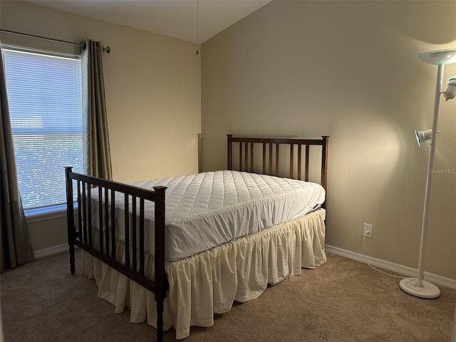 bedroom featuring carpet floors and vaulted ceiling