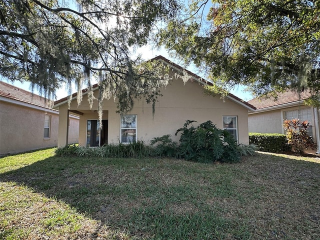 rear view of property with a yard