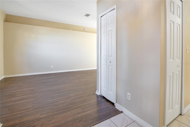 hallway featuring tile patterned flooring