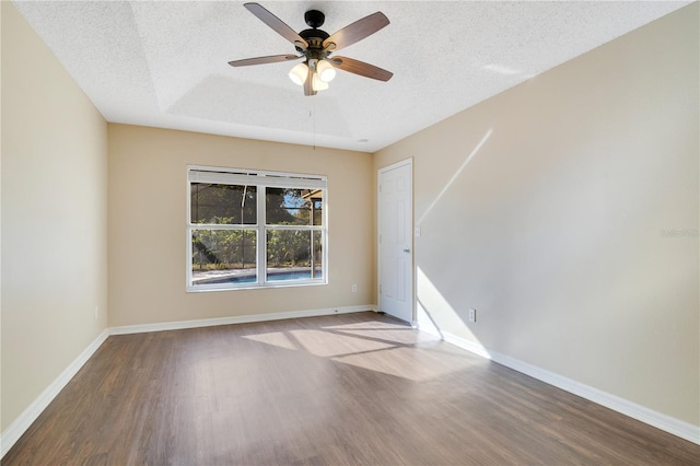 empty room with a textured ceiling, hardwood / wood-style flooring, and ceiling fan