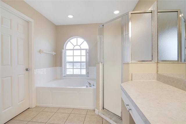 bathroom featuring tile patterned flooring, vanity, and separate shower and tub