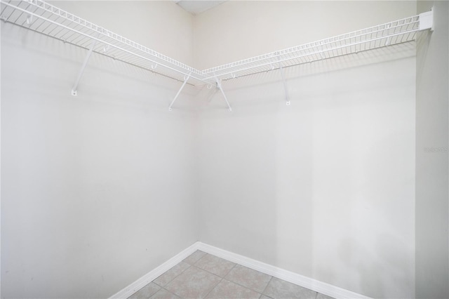 spacious closet with tile patterned floors