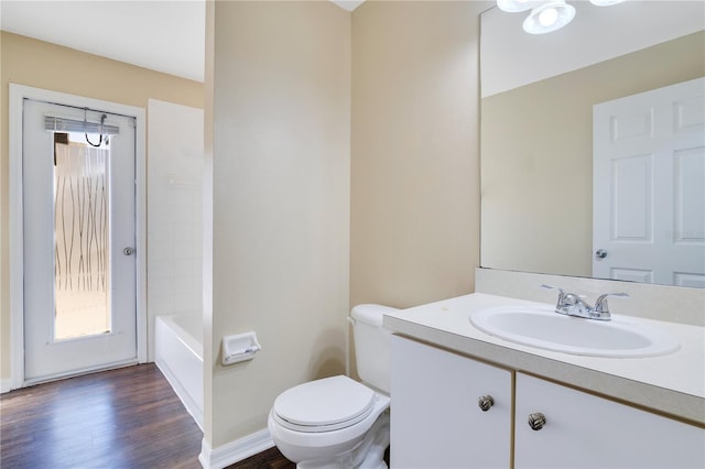 bathroom with hardwood / wood-style floors, vanity, and toilet