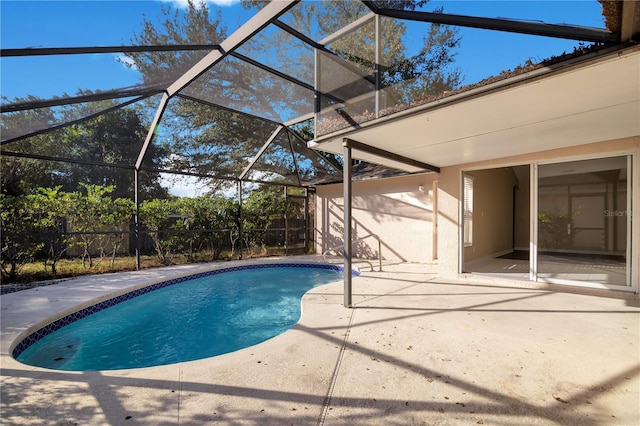 view of swimming pool with a lanai and a patio area