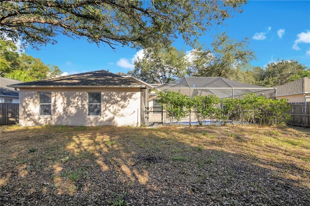 exterior space with a lawn and a lanai