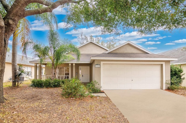 ranch-style home with covered porch and a garage