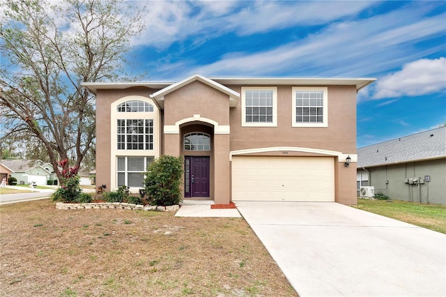 view of front property with ac unit and a garage