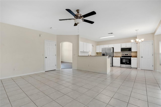 kitchen with white cabinetry, stainless steel appliances, decorative light fixtures, light tile patterned floors, and ceiling fan with notable chandelier