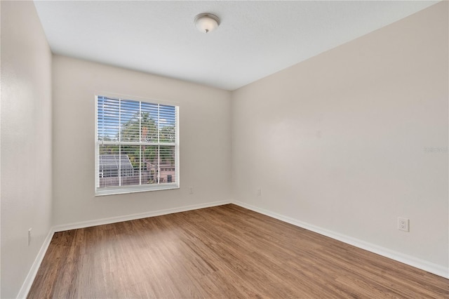 spare room with hardwood / wood-style flooring