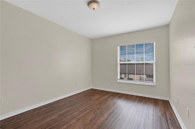 empty room featuring dark wood-type flooring