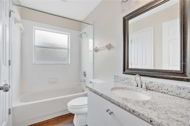 full bathroom with hardwood / wood-style flooring, vanity, toilet, and tiled shower / bath combo