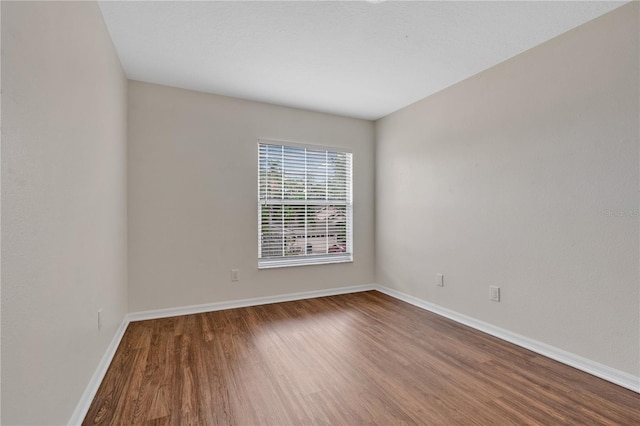 empty room with hardwood / wood-style flooring