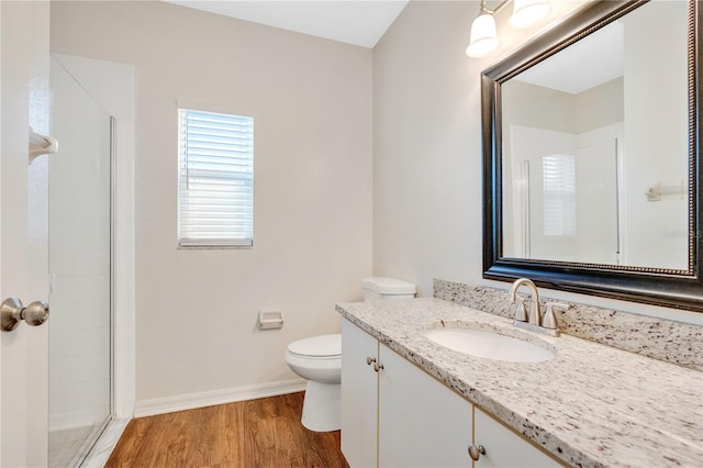 bathroom featuring hardwood / wood-style floors, vanity, toilet, and walk in shower