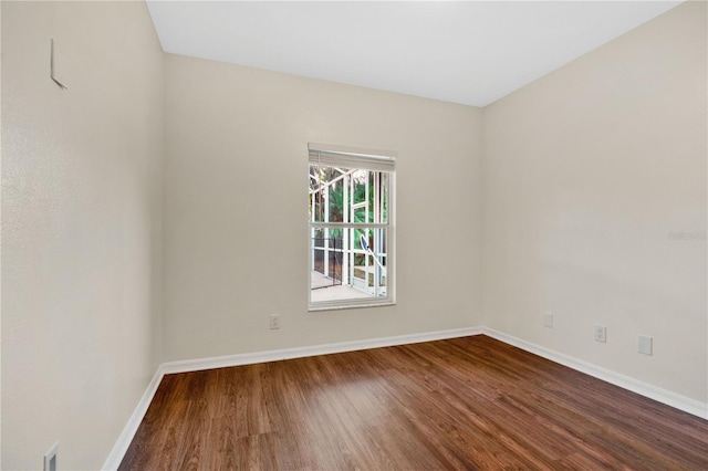 unfurnished room with hardwood / wood-style flooring