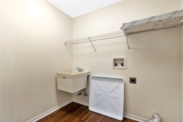 laundry room featuring electric dryer hookup, sink, washer hookup, and dark hardwood / wood-style floors