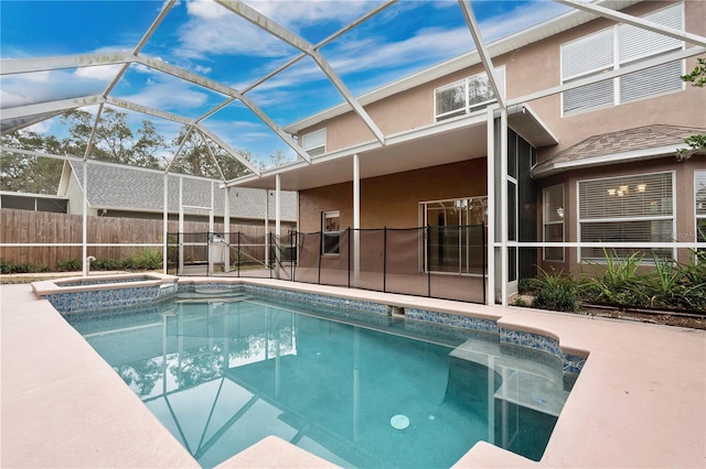 view of pool featuring a patio area, a lanai, and an in ground hot tub