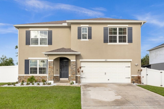 view of front of home with a front yard and a garage