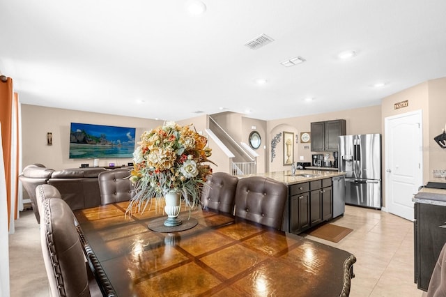 dining area featuring light tile patterned floors and sink