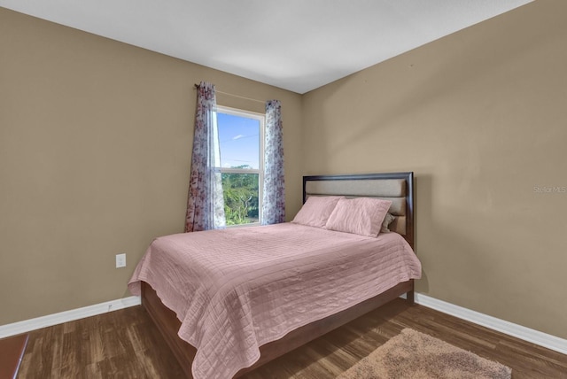 bedroom featuring dark hardwood / wood-style flooring