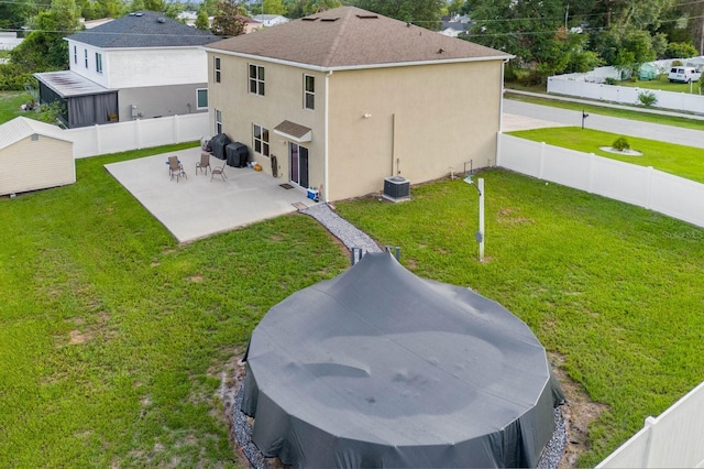 back of property featuring a patio and a lawn